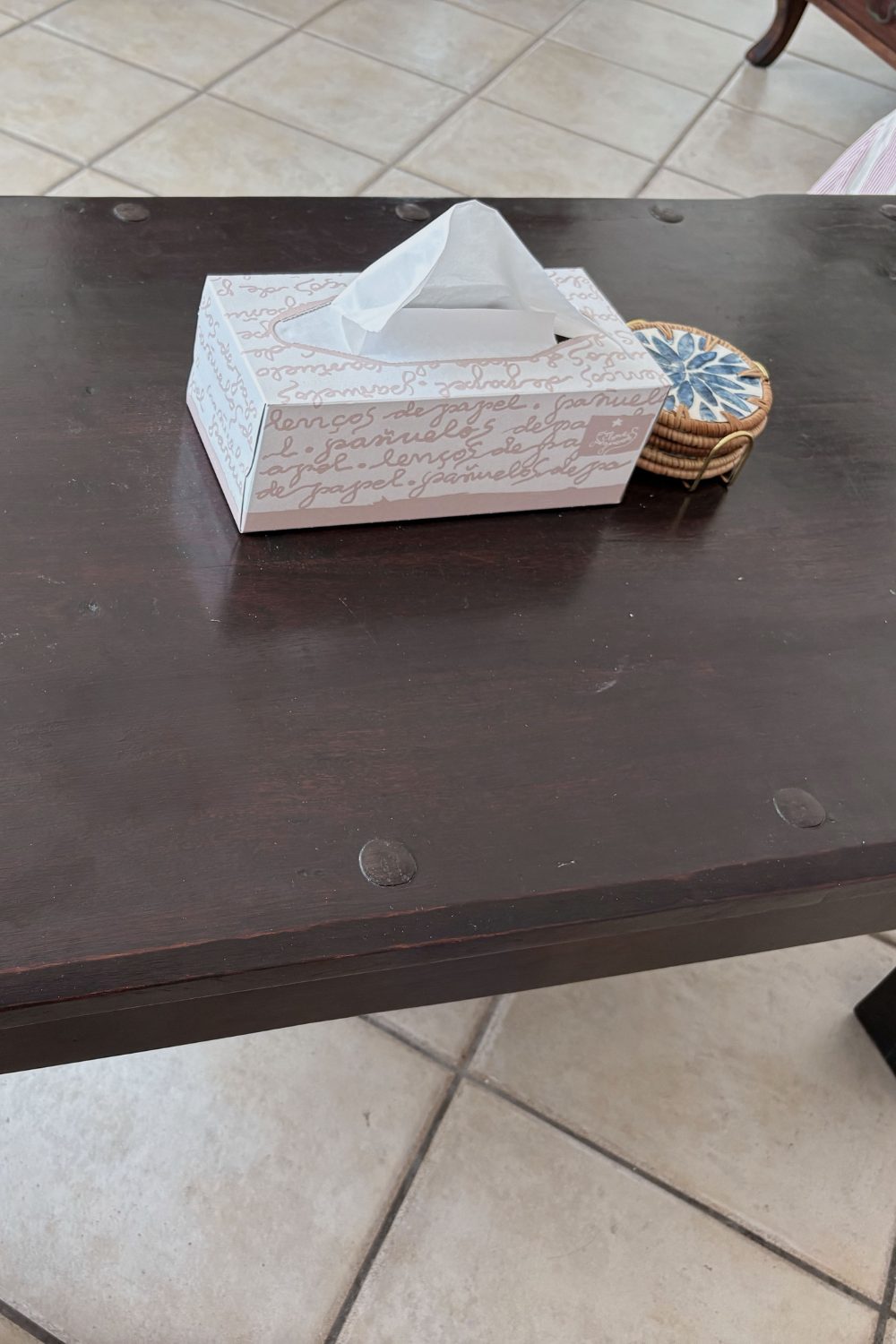 The same coffee table, cleared, with only a tissue box left